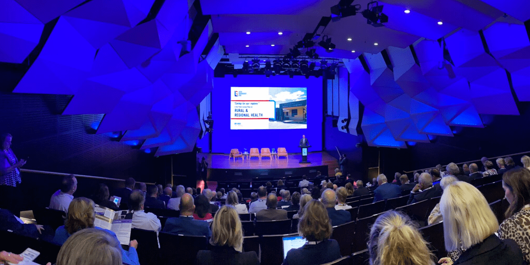 Regional and Rural Summit, backdrop of blue screen